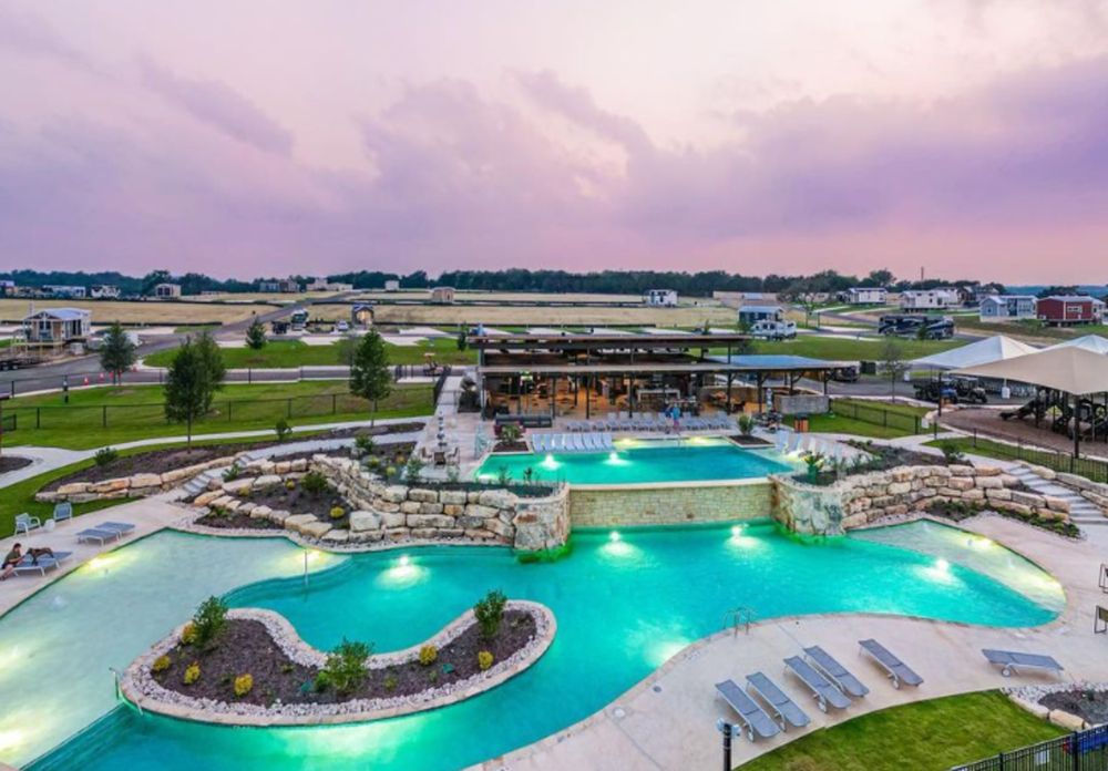 The resort pool glowing at dusk under pink skies